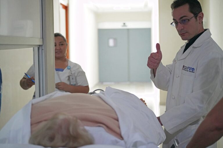 Medical personnel in hospital corridor.