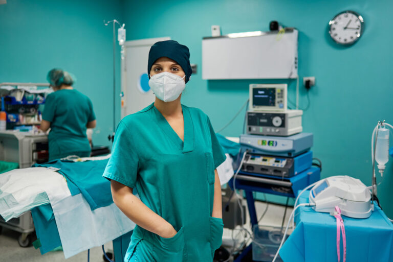 Surgeon in scrubs in clinic setting.