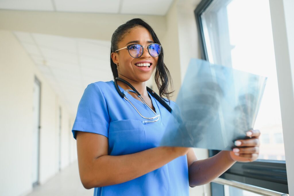 Neonatal Intensive Care Unit Nurse (NICU RN) 5 Doctor examining X-ray in hospital corridor.