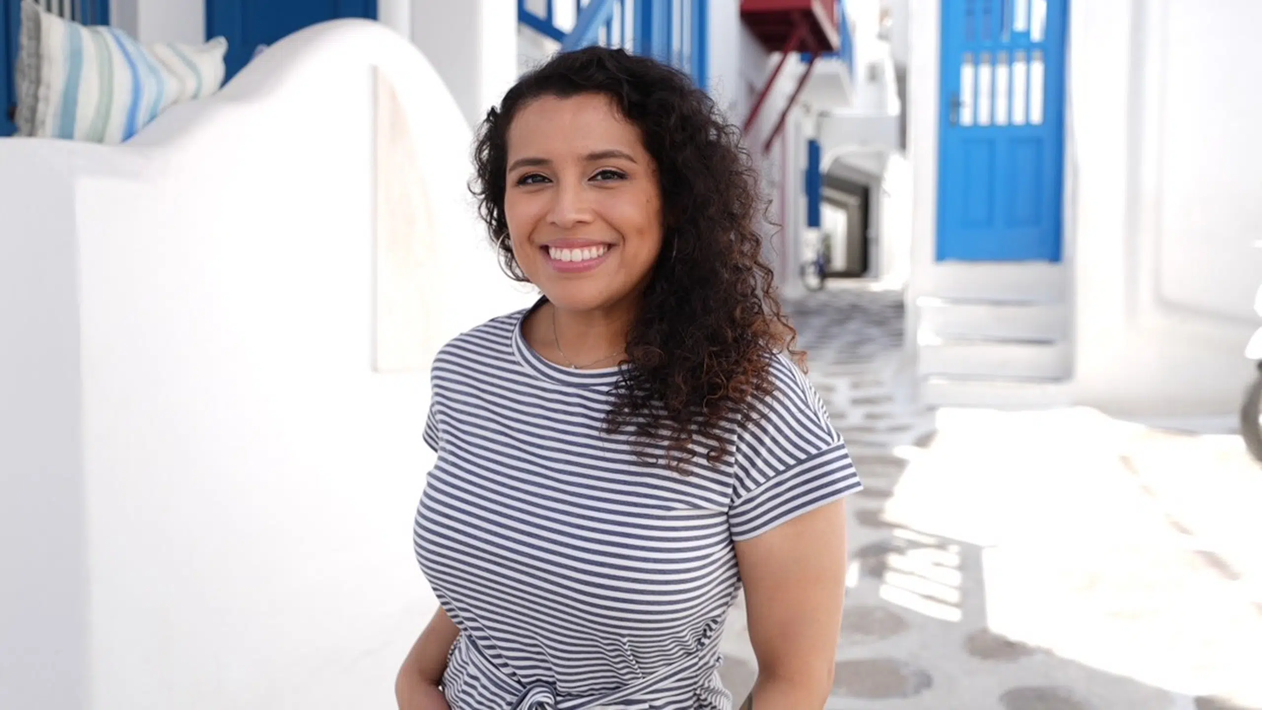 Seven Steps to Getting Started in Travel Nursing 1 Woman in striped shirt outdoors.