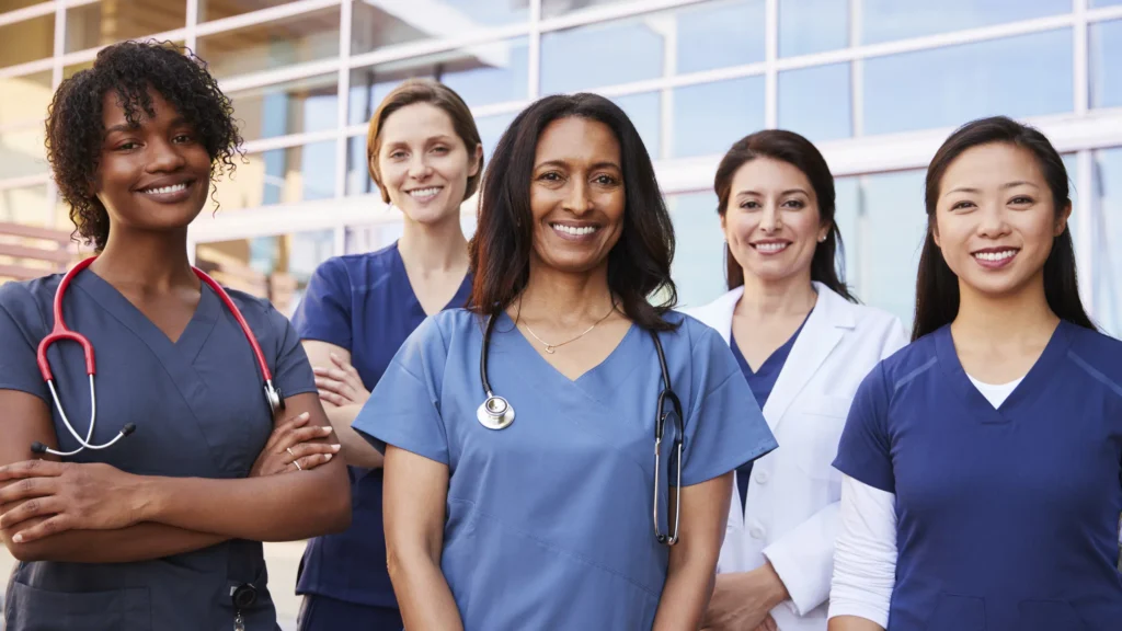 Female healthcare colleagues standing outside hospital