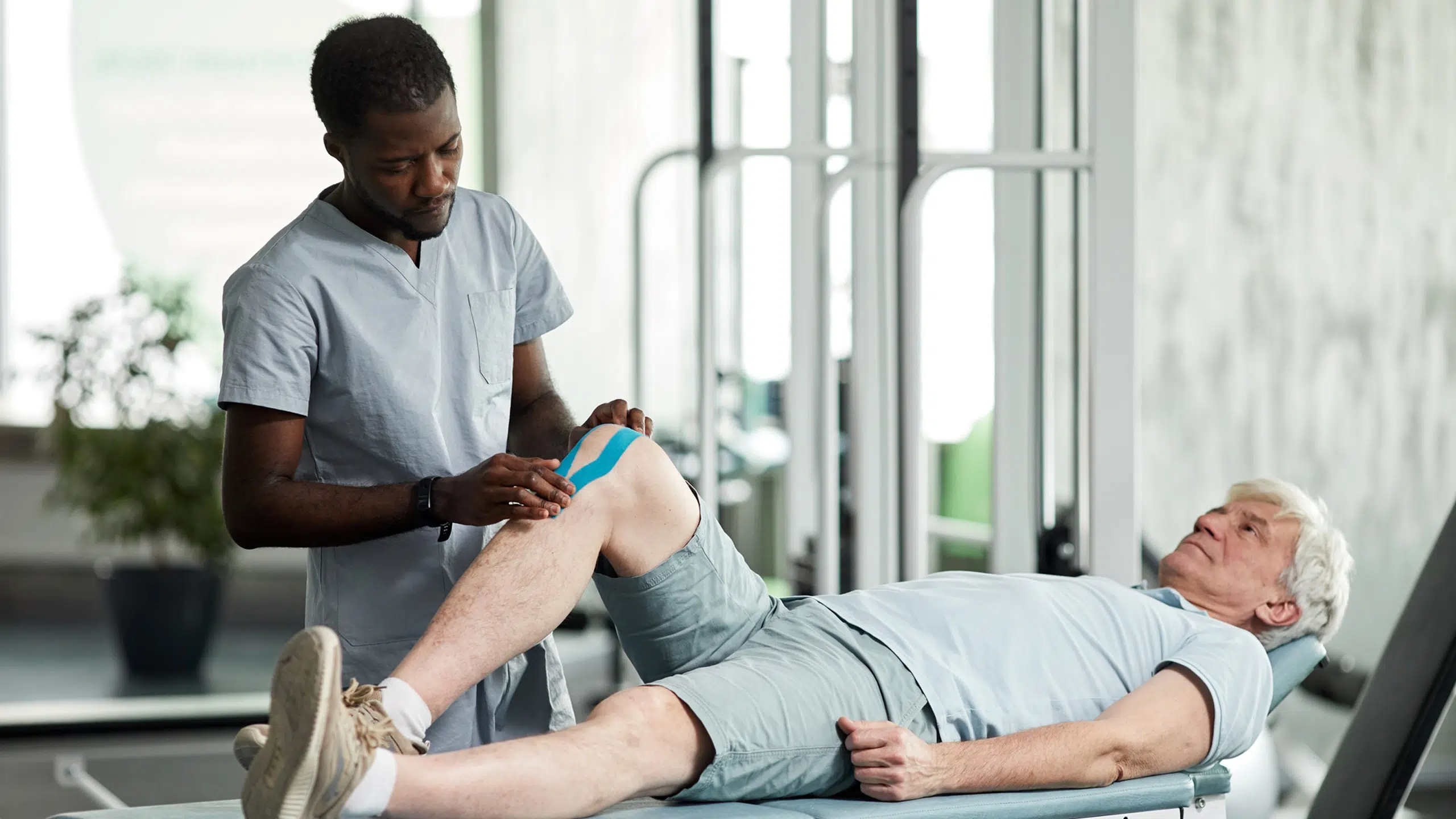 Rehabilitation Therapist Using Tapes