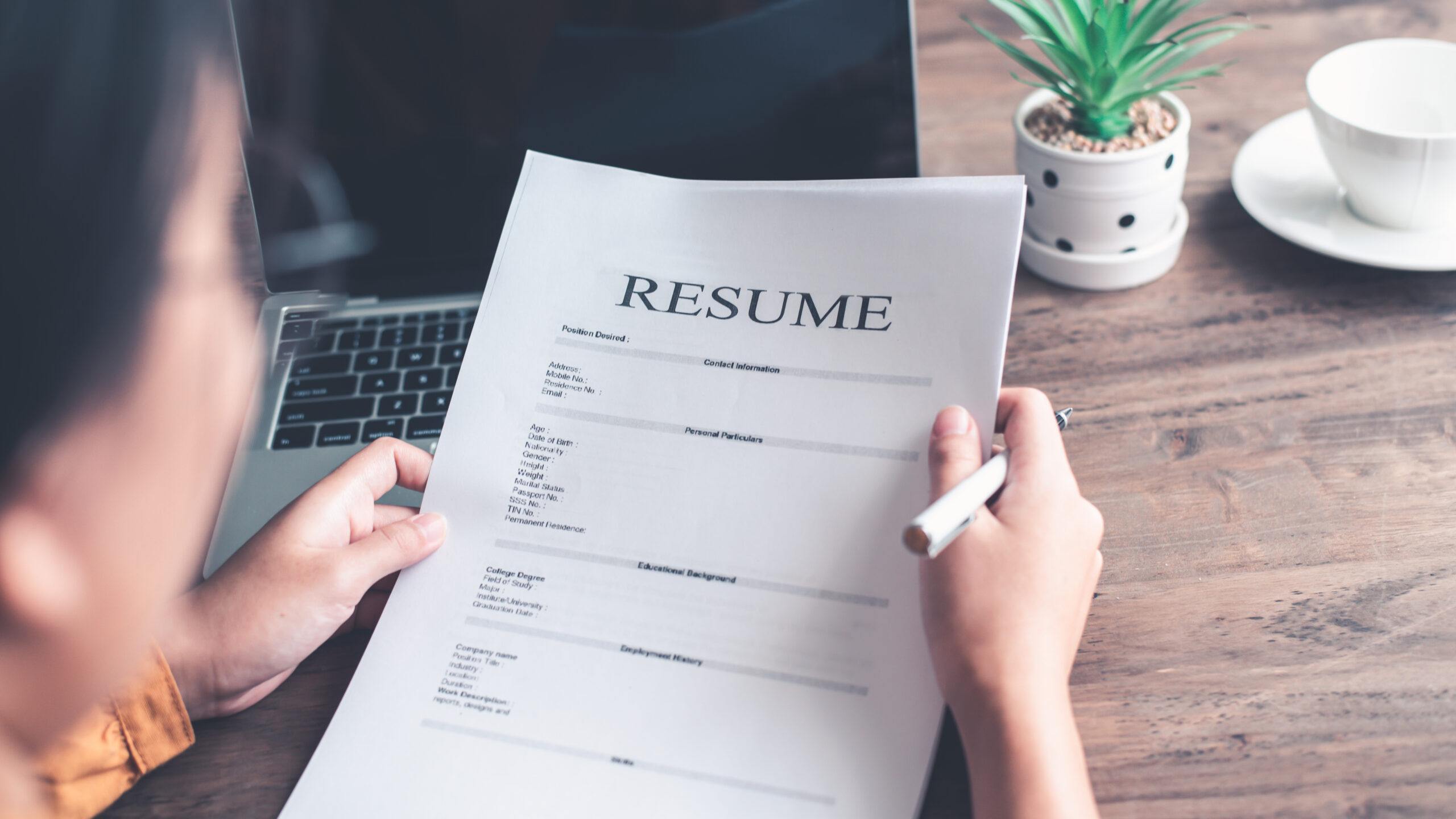 AI Can Build the Perfect Resume 1 Picture of woman looking over resume.