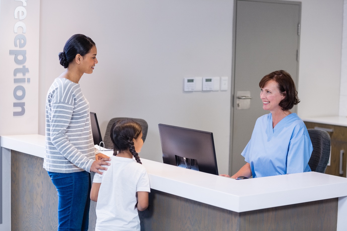Woman and child at reception desk.