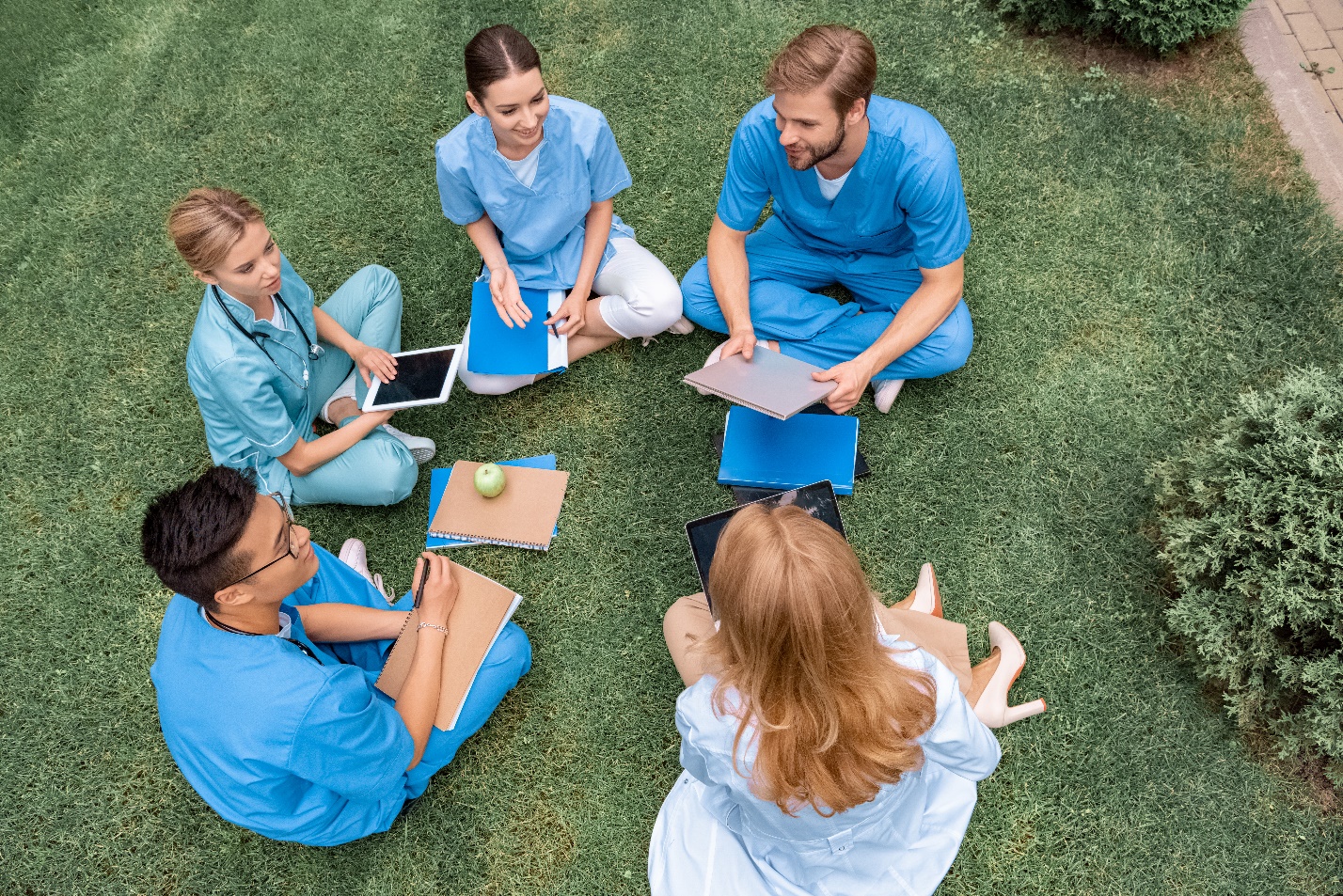 Group of people collaborating outdoors.