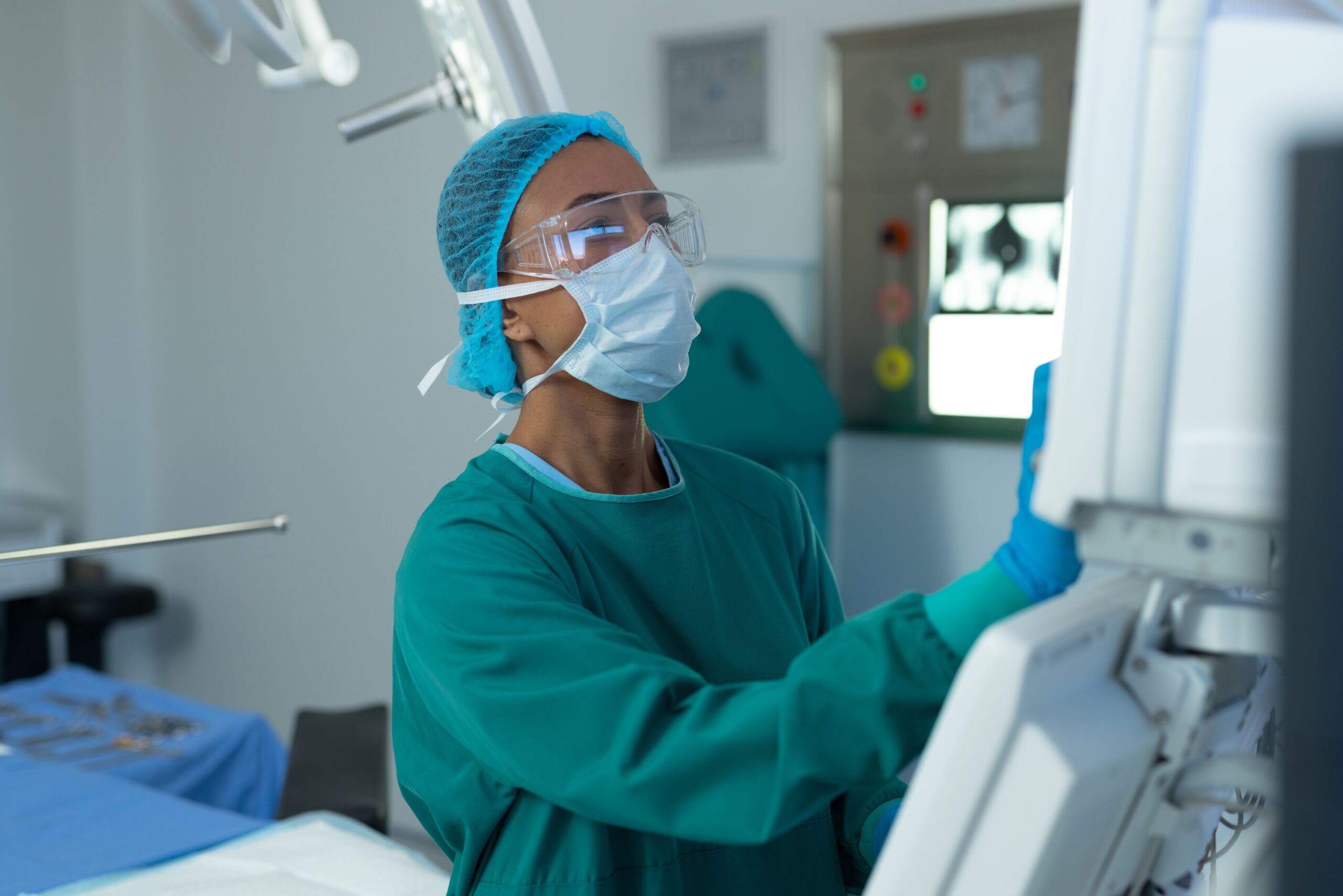 Medical professional operating surgical equipment.