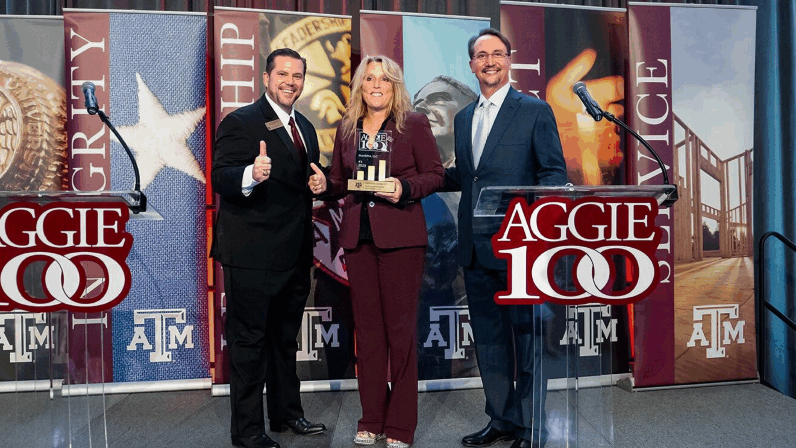 Award ceremony with three presenters.