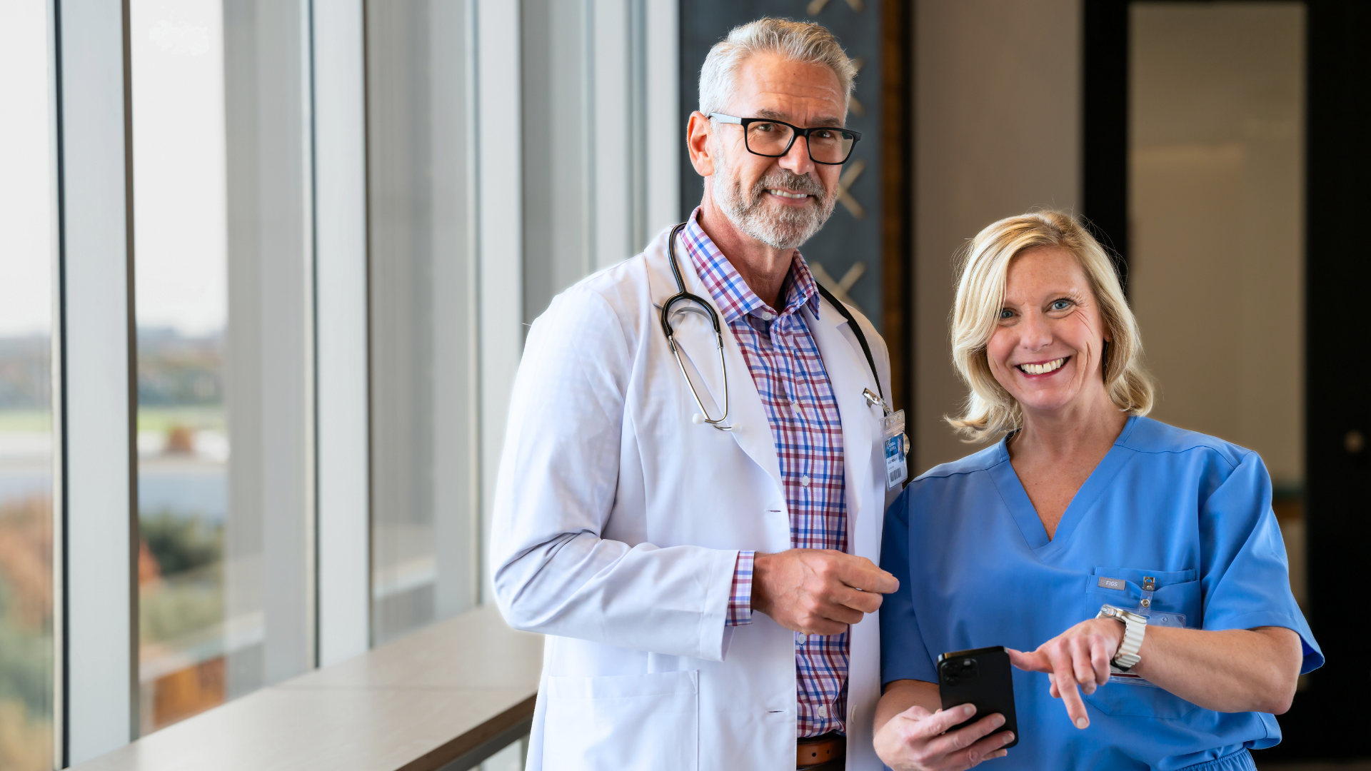 Medical professionals discussing on smartphone