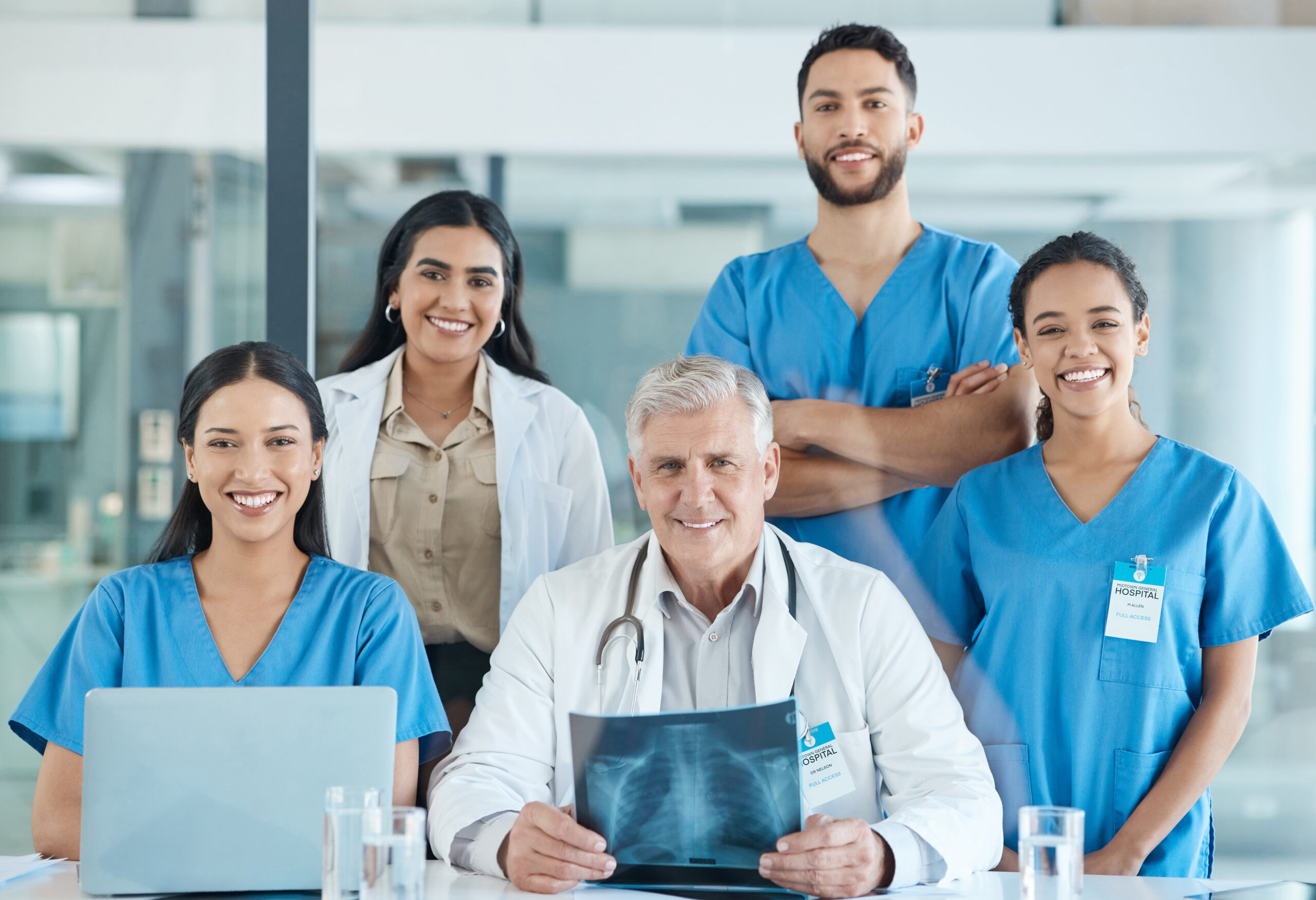 Medical team in blue scrubs meeting.