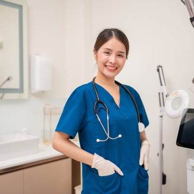 Nurse in scrubs with stethoscope.